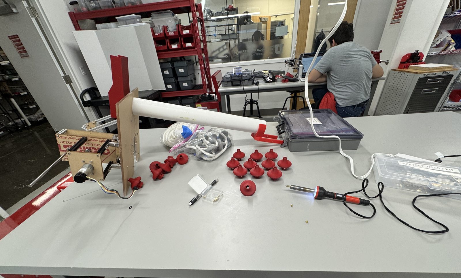 Water pump prototype on a lab bench with printed red impellers